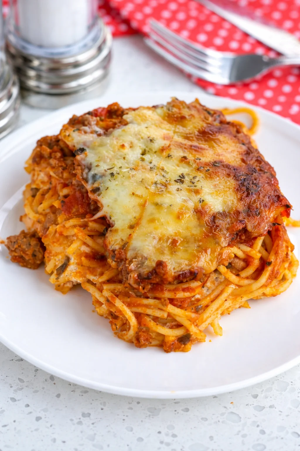 Baked Spaghetti Casserole with ground beef, creamy layers, and melted cheese