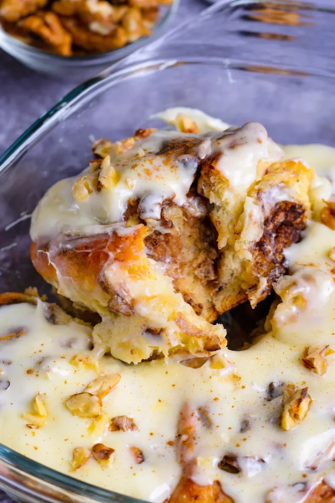 Freshly baked Banana Nut Cinnamon Rolls topped with nuts and cinnamon glaze.