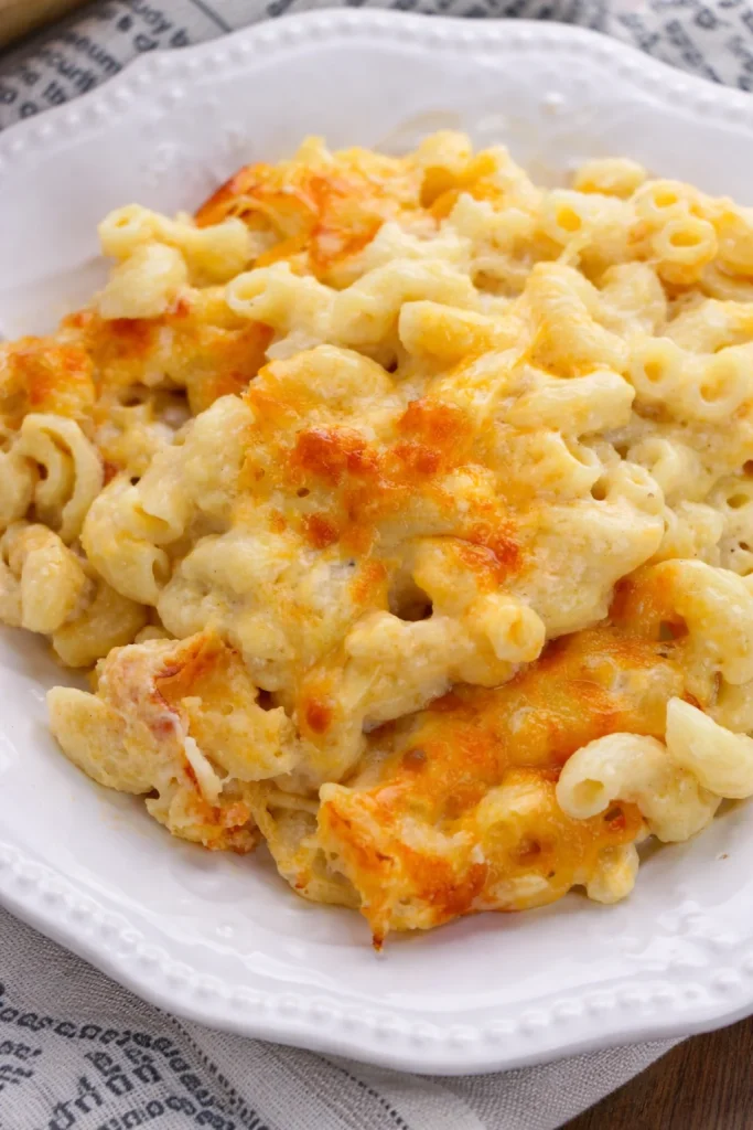 Delicious baked macaroni and cheese served in a bowl, topped with golden crust.