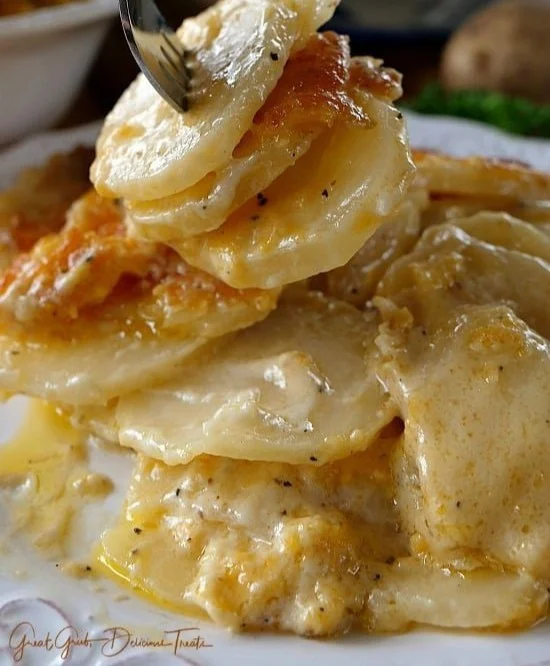 Delicious cheesy garlic scalloped potatoes baked in a creamy sauce