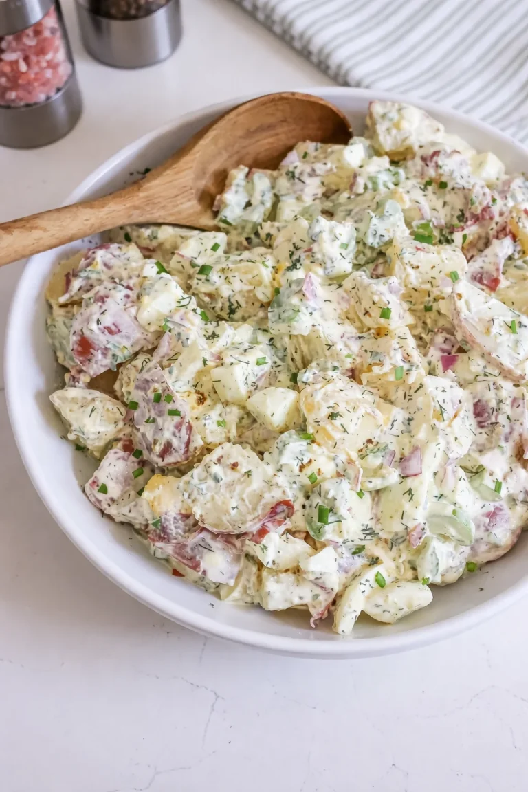 Classic Red Potato Salad served in a bowl with fresh herbs and dressing