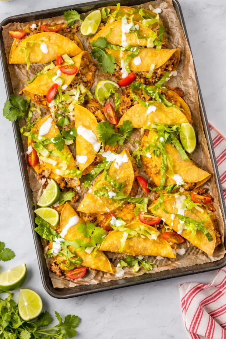 Crispy beef tacos topped with fresh ingredients and garnishes