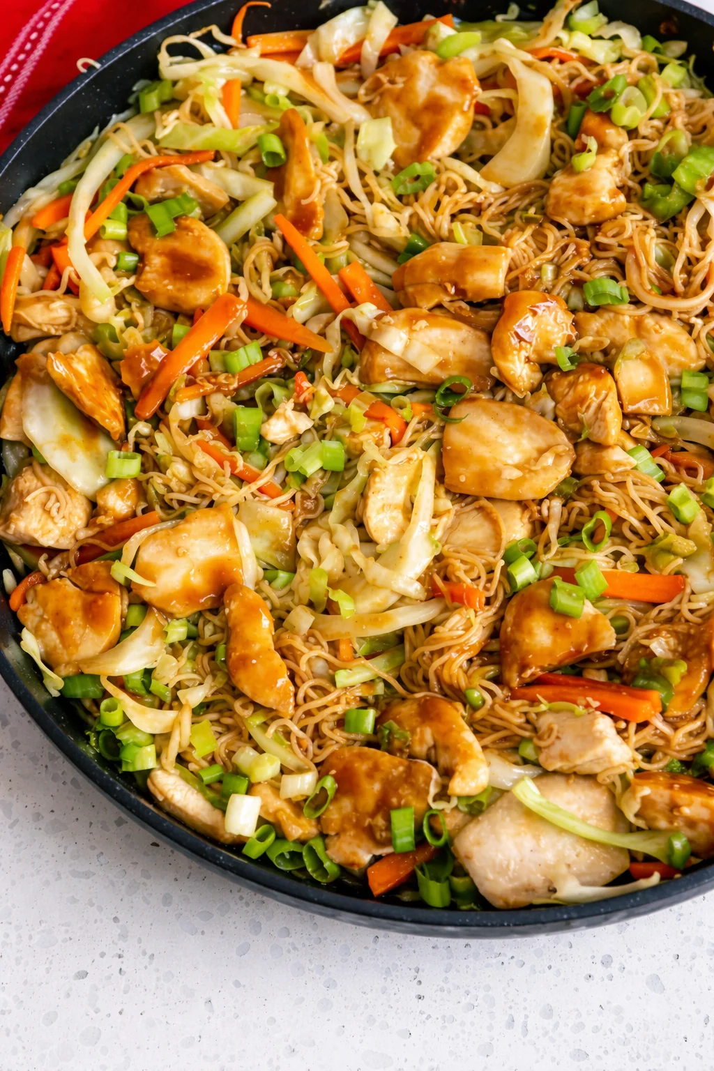 Delicious Chicken Chow Mein with crispy noodles, chicken, cabbage, carrots, and sauce.