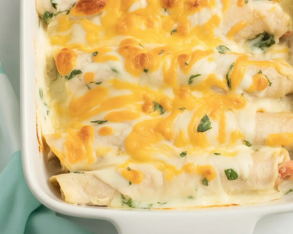 Deliciously Easy Sour Cream Chicken Enchiladas to Savor Delicious Sour Cream Chicken Enchiladas served with a side of guacamole.