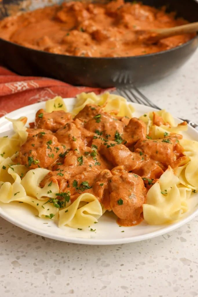 Easy Chicken Paprikash combines bite-sized pieces of chicken pan-fried in butter, all smothered in a creamy sauce seasoned with sweet Hungarian paprika.