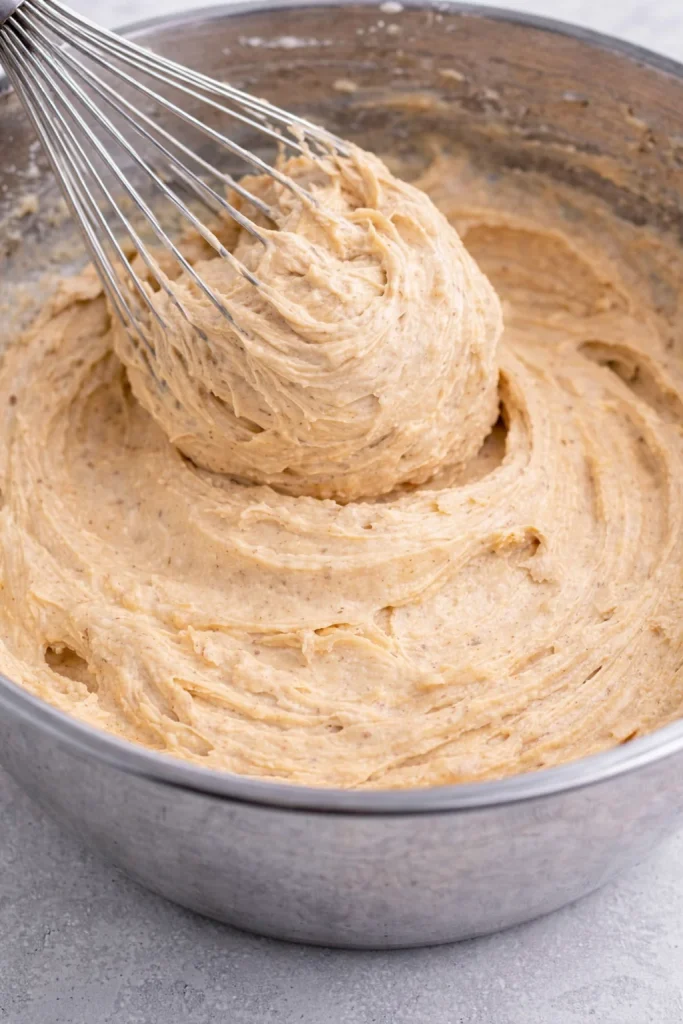 Delicious easy peanut butter frosting spread on cupcakes.