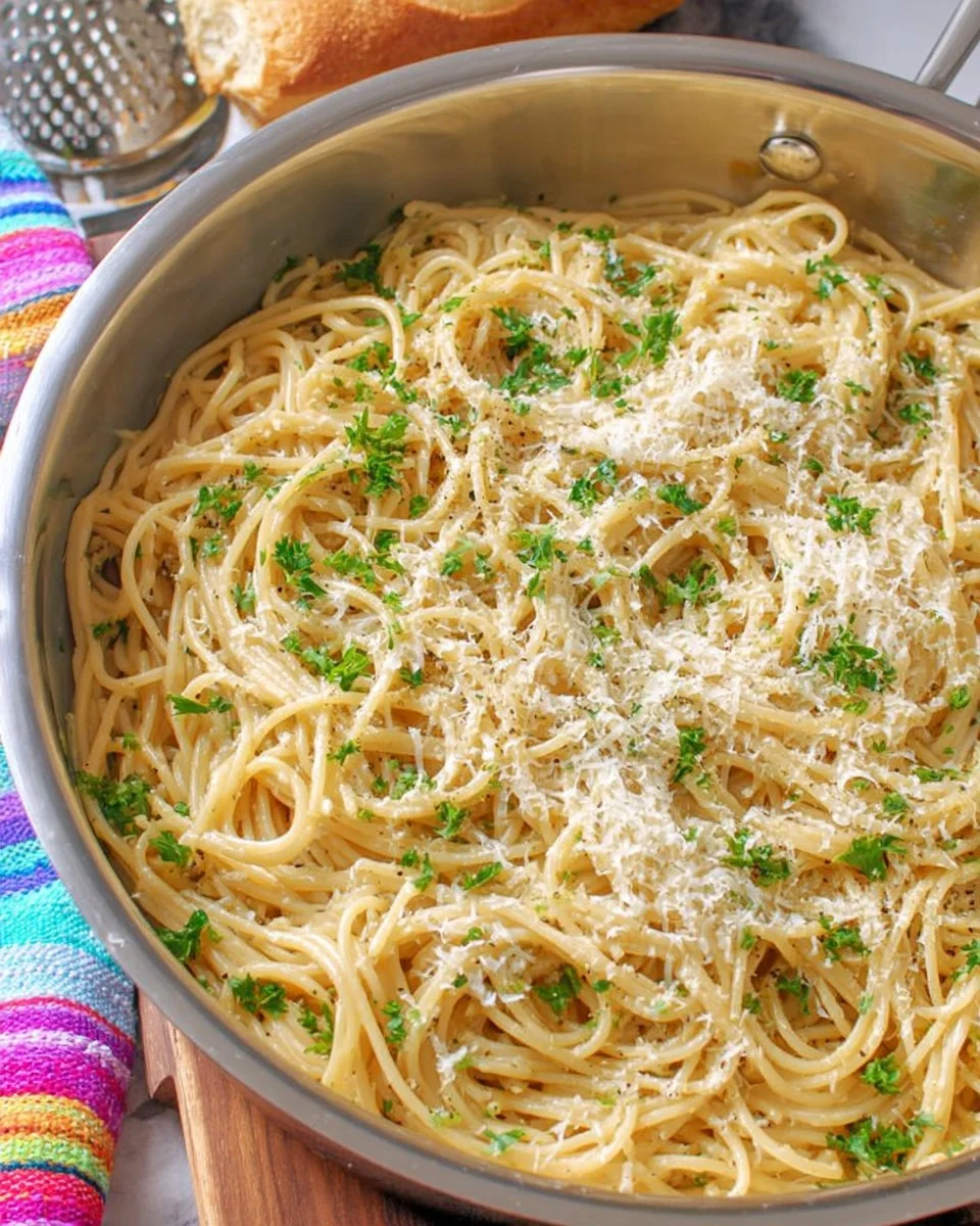 Bowl of creamy Garlic Parmesan Pasta garnished with parsley and cheese
