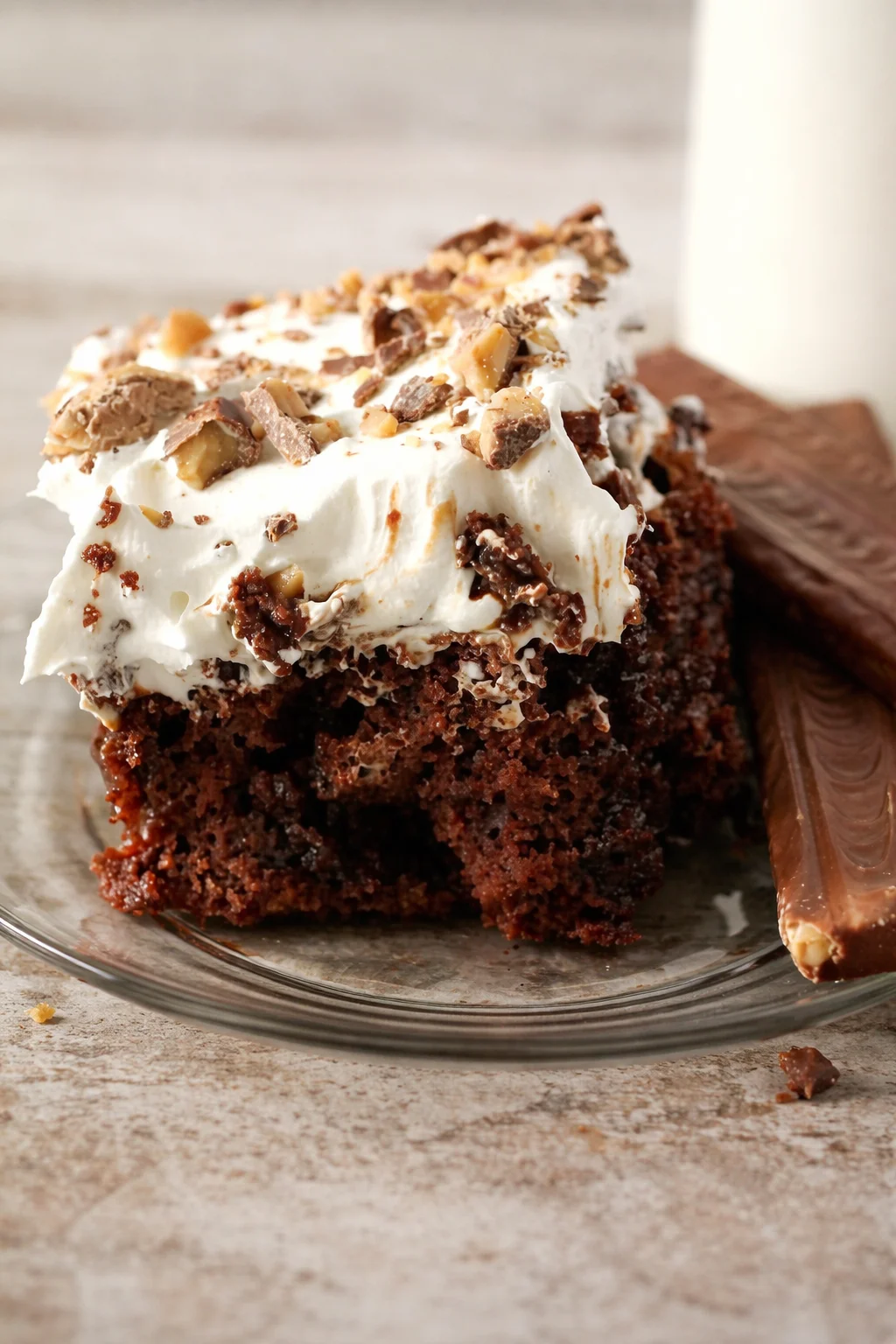 Heath Bar Poke Cake topped with chocolate and toffee bits