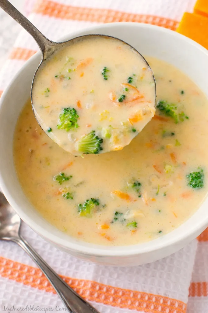 Bowl of homemade Panera broccoli cheese soup garnished with fresh herbs