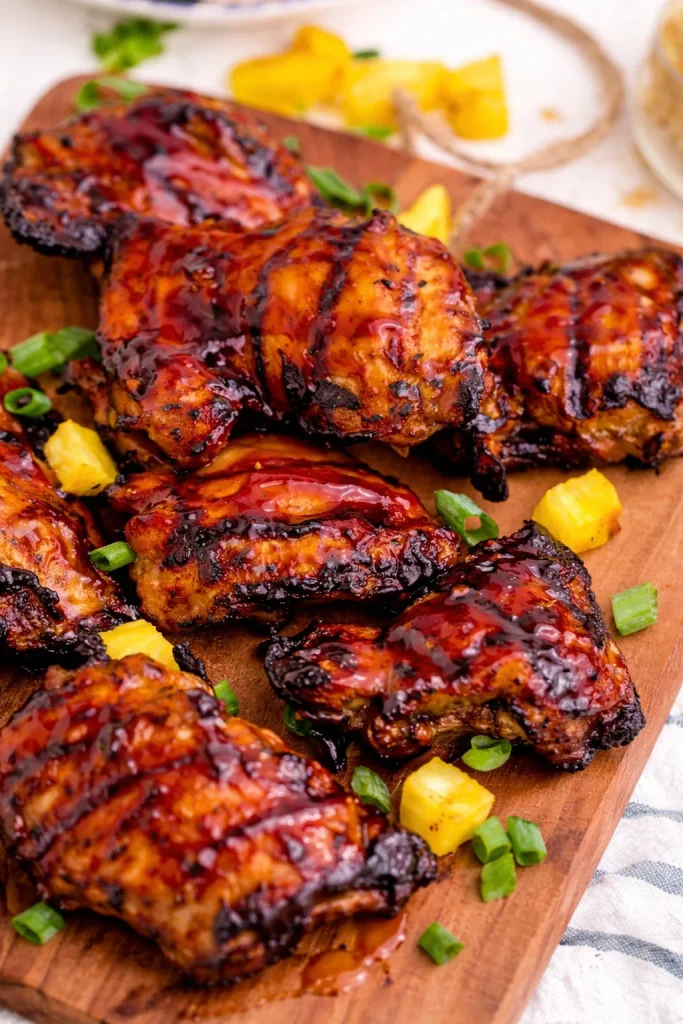 Grilled Huli Huli Chicken with a tropical marinade garnished with green onions
