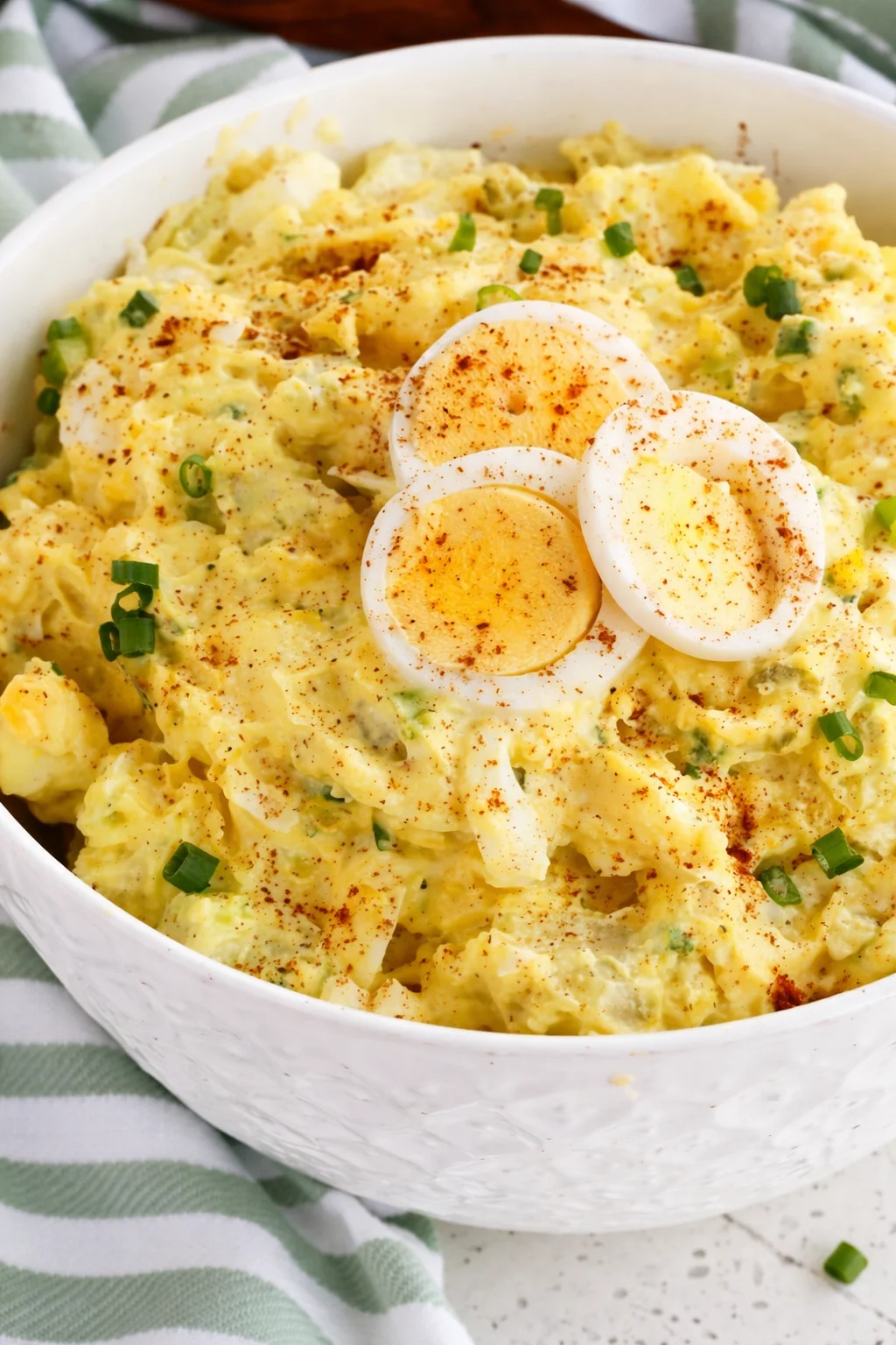 Delicious southern potato salad with creamy dressing, eggs, and veggies.