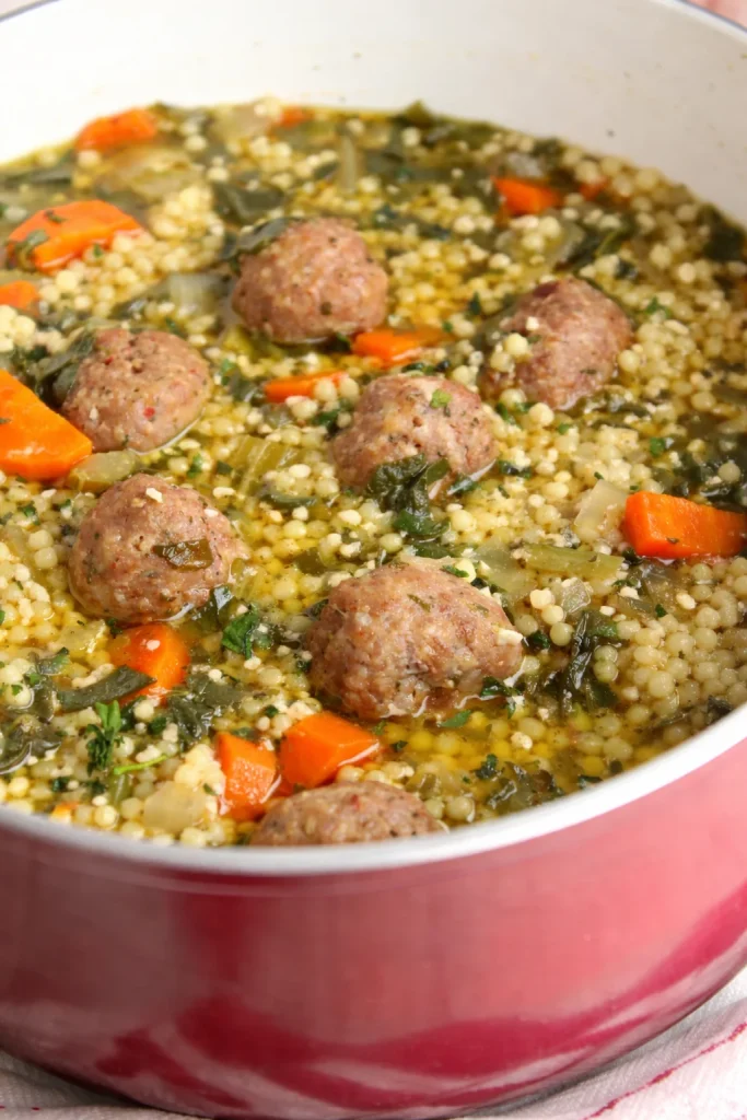 Bowl of Italian Wedding Soup with meatballs, greens, and broth.