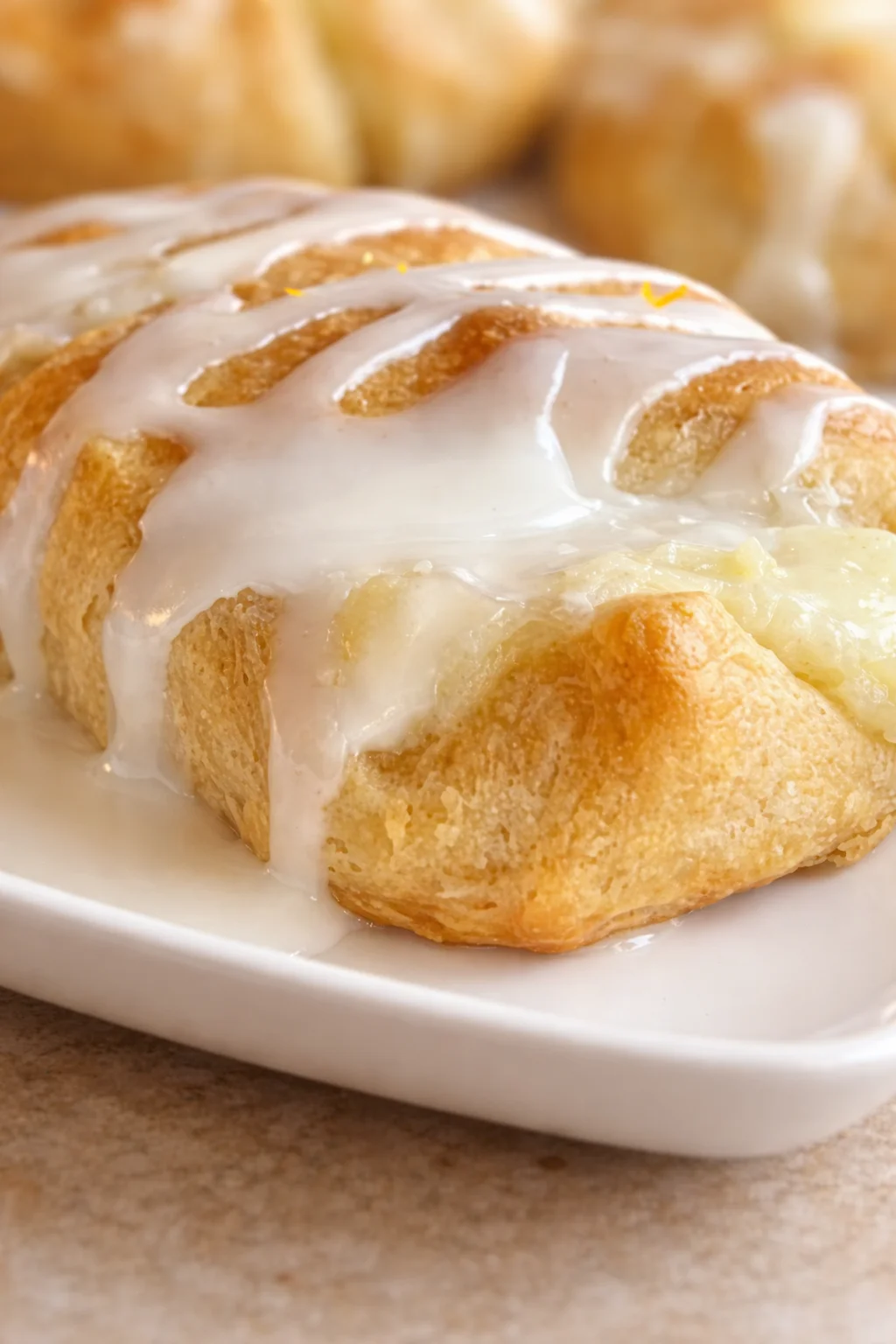 Delicious lemon cheesecake crescent rolls placed on a decorative plate