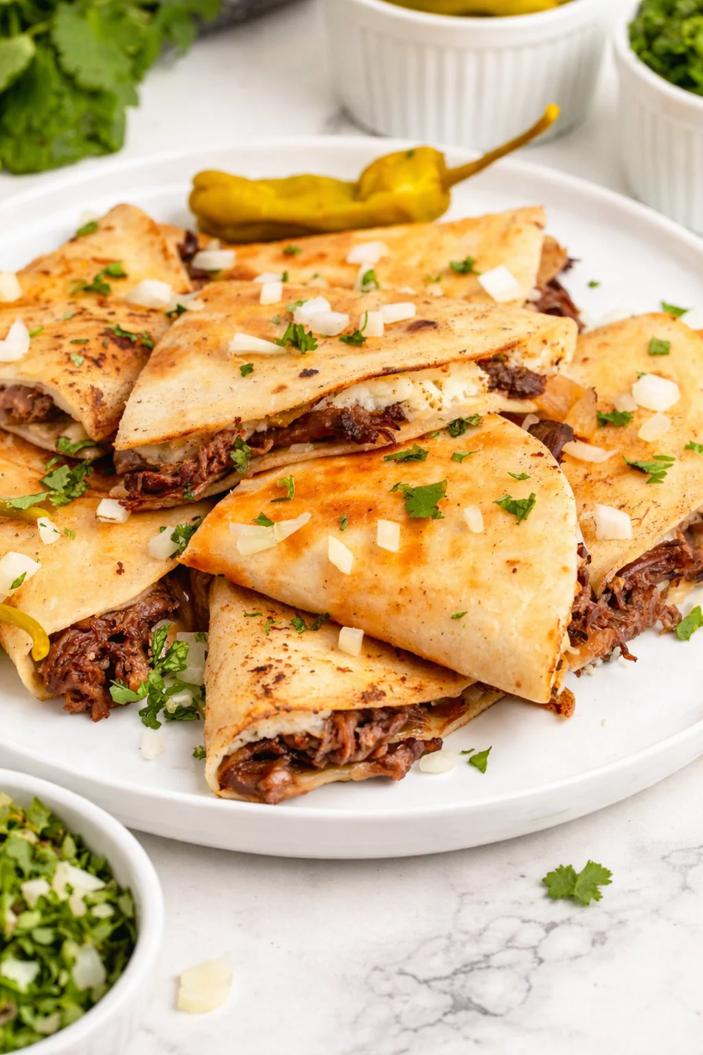 Delicious Mississippi Pot Roast Quesadillas served on a plate with toppings