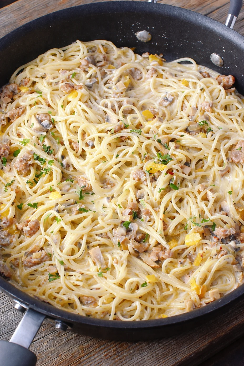 Creamy Sausage Boursin Pasta with sausage and herbs in a white bowl