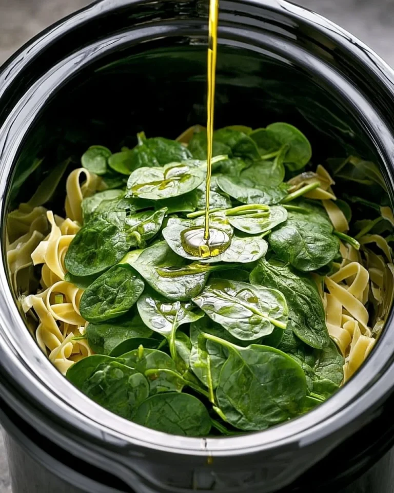 Delicious slow cooker spinach pasta primavera with fresh vegetables.