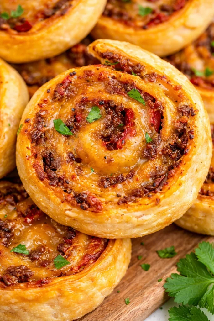 Taco Pinwheels filled with seasoned beef, cheese, and toppings rolled in tortillas.