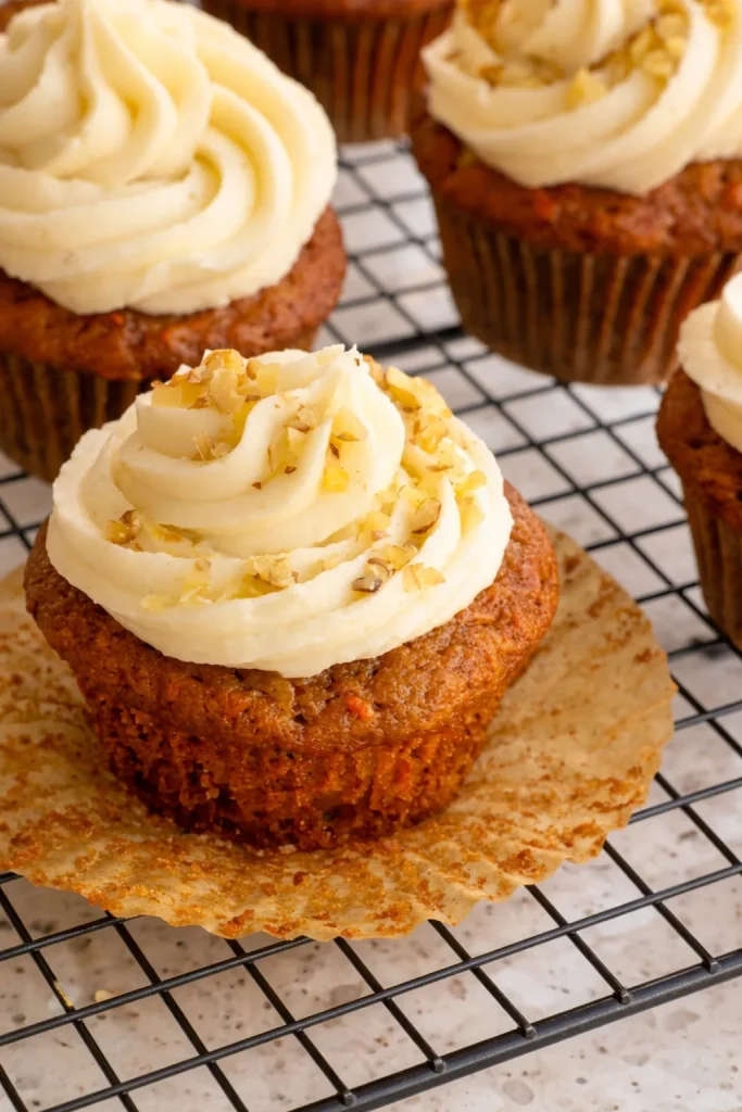 These delicious, moist Carrot Cake Cupcakes with crushed pineapple and the perfect blend of spices, all topped with a homemade cream cheese frosting.