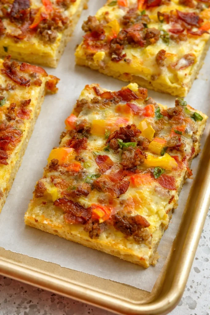 Delicious Breakfast Pizza topped with bacon, sausage, peppers, onions, and melted cheese.