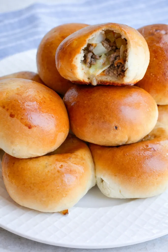 This Runza Recipe uses already-prepared frozen bread dough and browned ground beef mixed with onion and green cabbage and seasoned with salt and fresh ground black pepper.