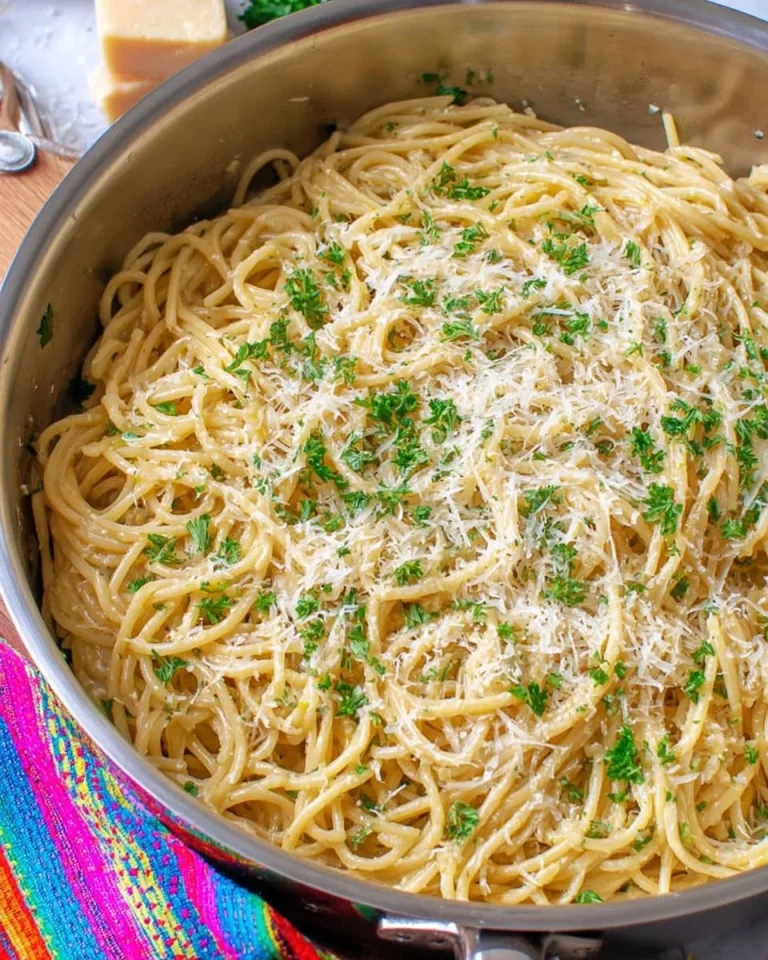 Delicious serving of garlic parmesan pasta topped with fresh parsley