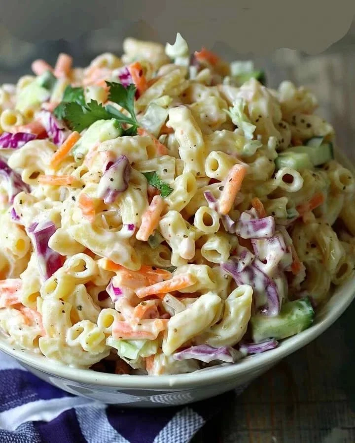Coleslaw Pasta Salad Bowl of coleslaw pasta salad with fresh vegetables and dressing