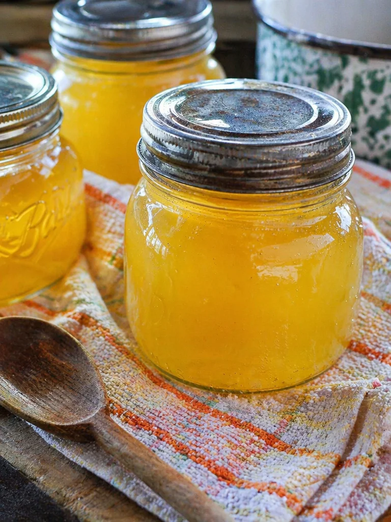 Homemade dandelion jelly in glass jars on a wooden table