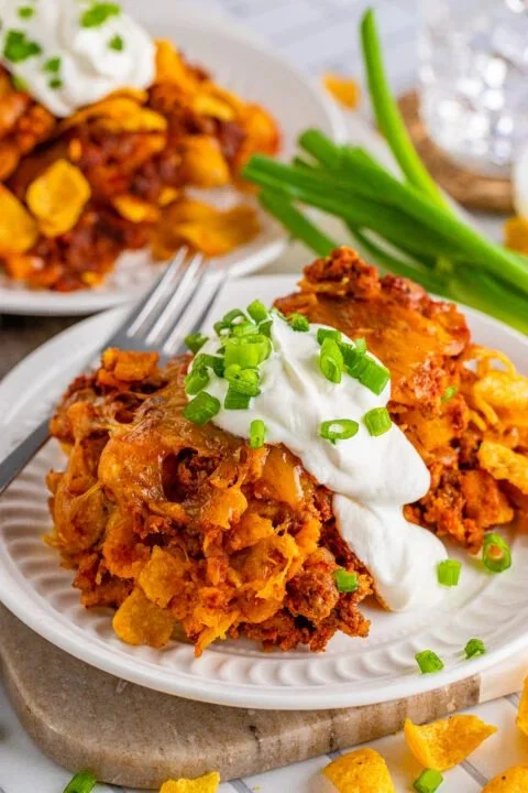 Frito Cheesy Chili Casserole Frito Cheesy Chili Casserole served in a baking dish topped with cheese