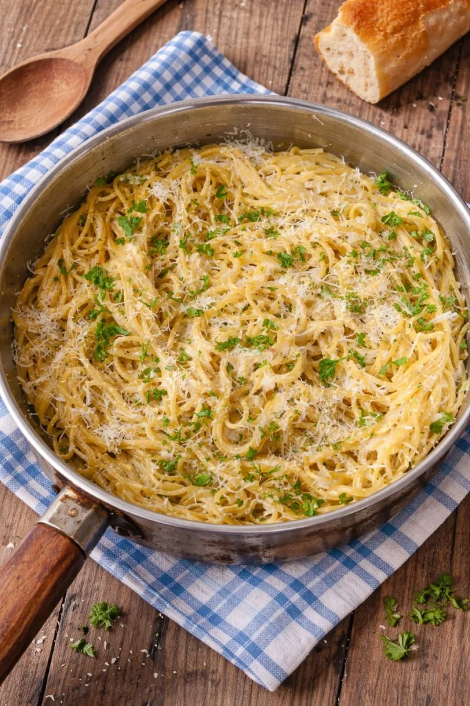 Delicious bowl of Garlic Parmesan Pasta topped with herbs and cheese