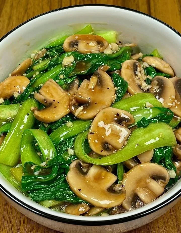 A flavorful dish of sautéed mushrooms and bok choy served in a bowl