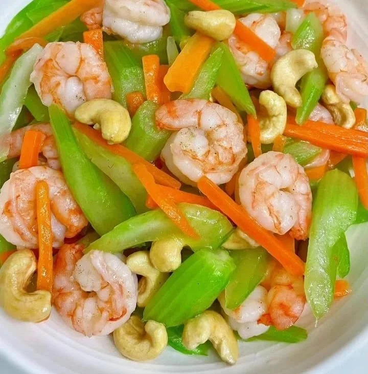 Shrimp stir-fry with celery and carrots served on a plate