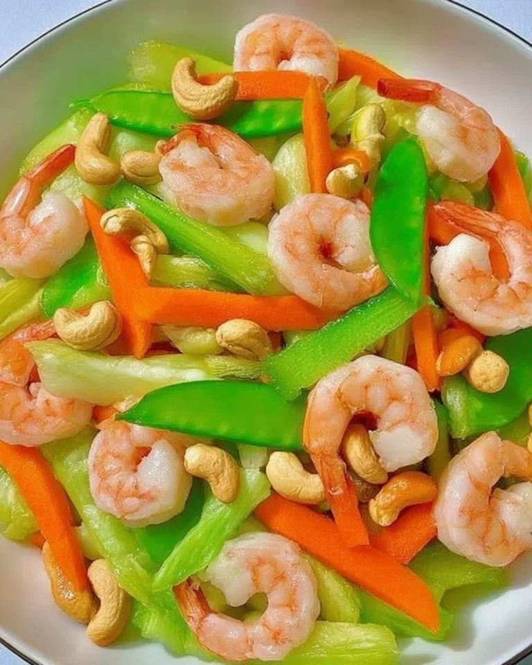 Shrimp, Celery, and Carrot Stir-fry with Cashews Shrimp stir-fry with celery, carrots, and cashews served in a bowl