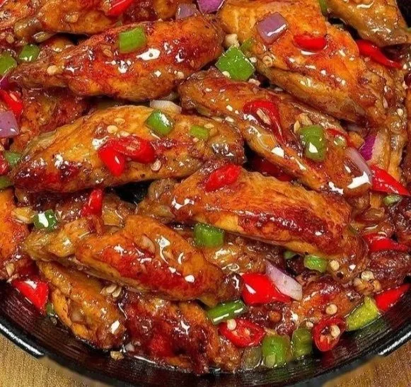 Spicy garlic chicken wings served with dipping sauce on a plate