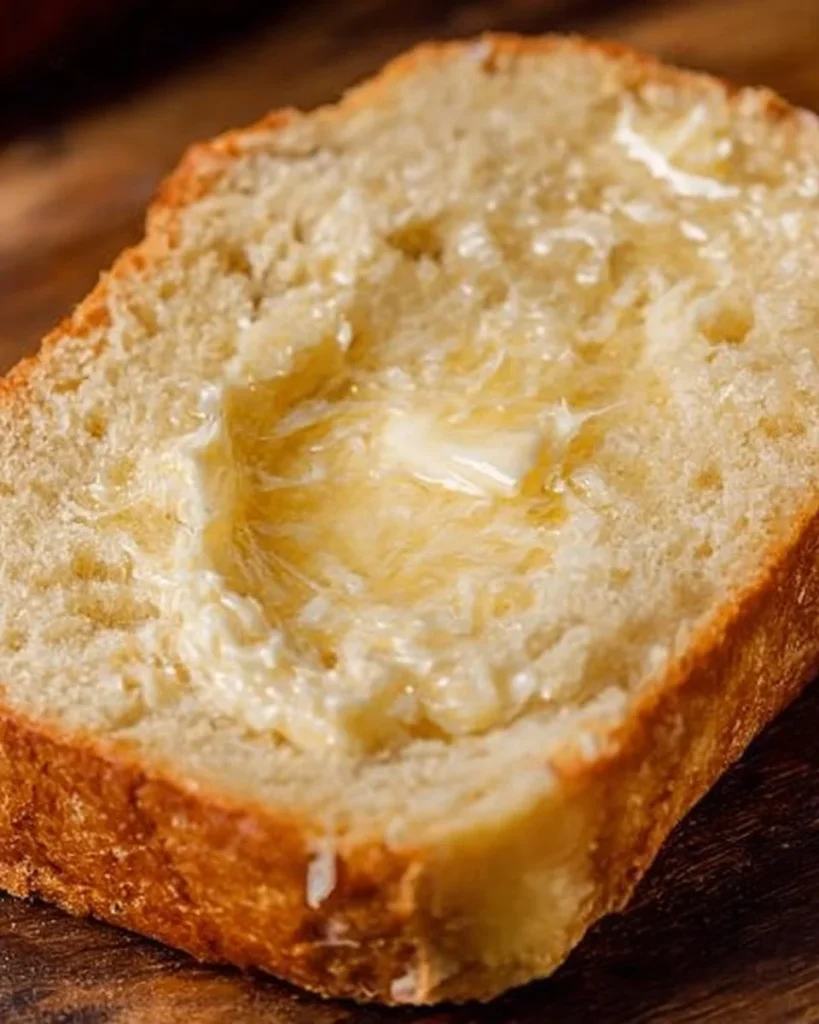 Homemade Amish Bread fresh out of the oven, showcasing its texture and crust.