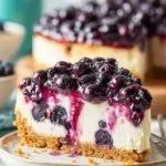 Delicious blueberry cheesecake topped with fresh blueberries and a graham cracker crust