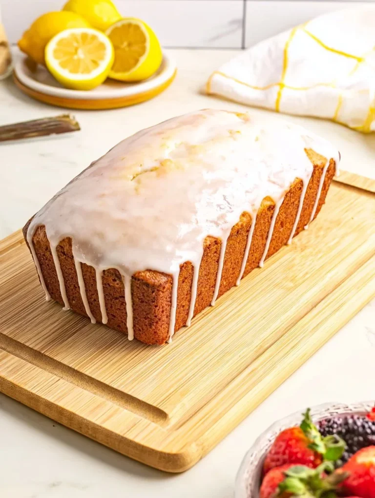 Lemon Loaf Cake Freshly baked Lemon Loaf Cake garnished with lemon slices and icing.
