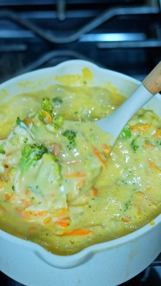Creamy Broccoli Soup Bowl of creamy broccoli soup garnished with croutons and herbs.