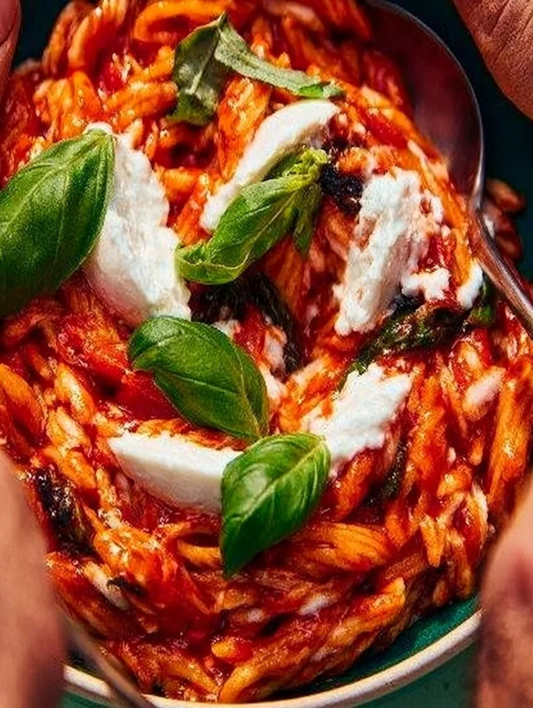 Creamy Goat Cheese & Roasted Red Pepper Risoni (Orzo) Creamy goat cheese and roasted red pepper risoni dish garnished with fresh herbs