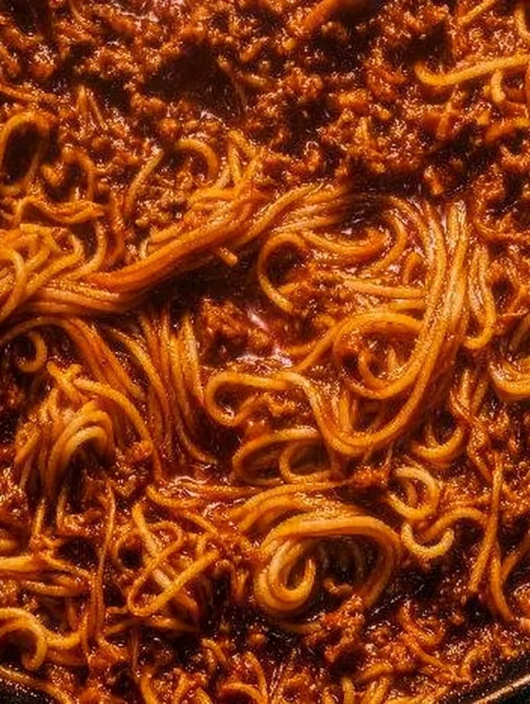 Delicious one pot Pasta Bolognese served with fresh herbs.