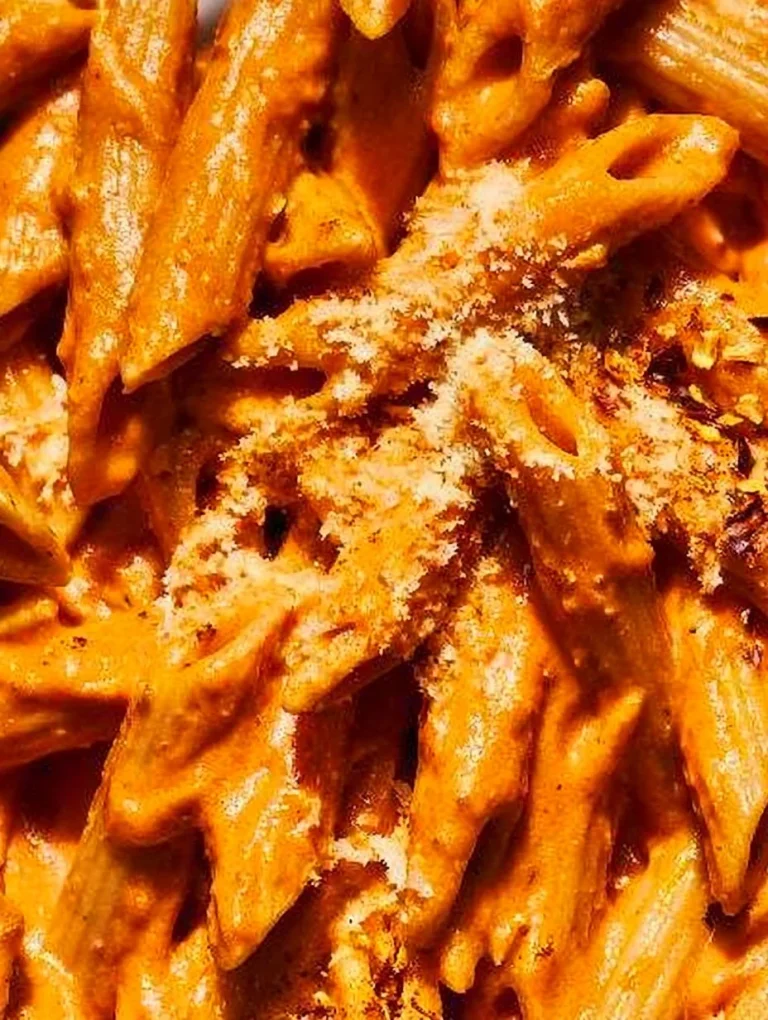 Pasta with Vodka Plate of pasta with vodka sauce garnished with basil and Parmesan cheese